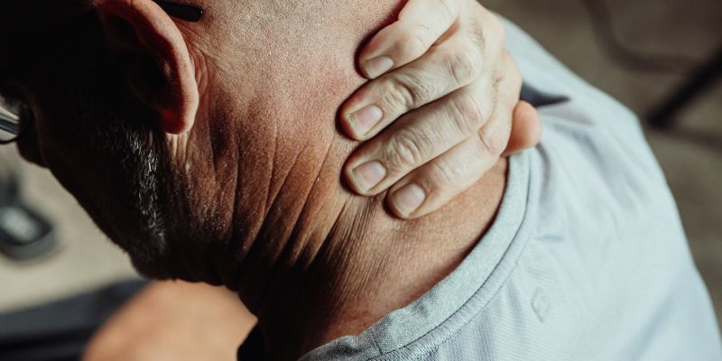 Man holding neck